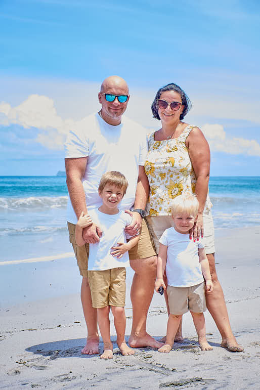 Costa Rican vacation with family and palm trees enjoying the crystal clear water