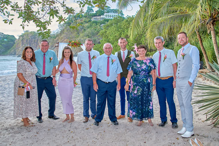 Costa Rican beach scene featuring a family enjoying the clear water and palm trees